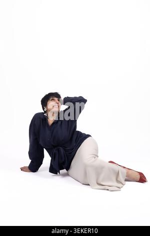 Athletic young man lying relaxed on floor leaning back looking up Stock Photo