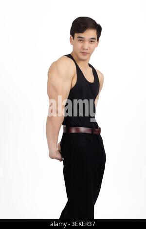 Athletic young man standing side profile looking at camera confidently Stock Photo
