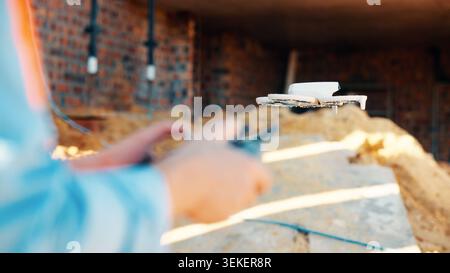Construction, hands and worker with drone on site for surveying, safety inspection or monitoring. Surveyor, person or UAV tech outdoor for tracking Stock Photo