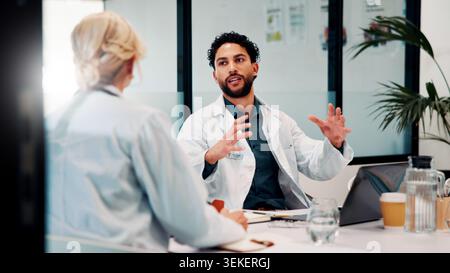 Laptop, discussion and doctors in office for research on medical diagnosis, treatment or surgery plan. Computer, meeting and team of healthcare Stock Photo