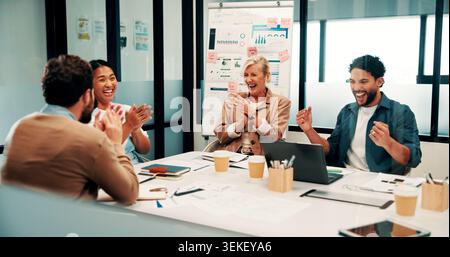 Success, meeting and business people with applause, celebration or excited for financial growth. Achievement, milestone and group with analyst for Stock Photo