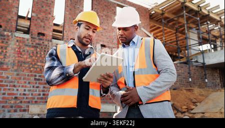 Team, scroll and men with tablet at construction site, civil engineer and project update on website. Outdoor, architecture and people with tech for Stock Photo
