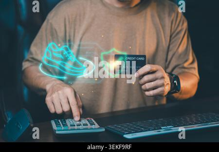 Man holding credit card with virtual running shoe icon and secure shield. Online fashion shopping, sportswear e-commerce concept. Stock Photo