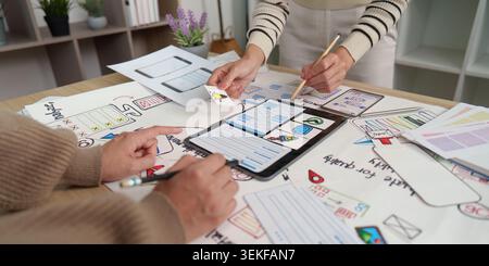 Women designers collaborating on UI UX mobile app development with tablet Stock Photo