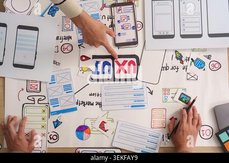 Women designers collaborating on UI UX mobile app wireframe planning Stock Photo