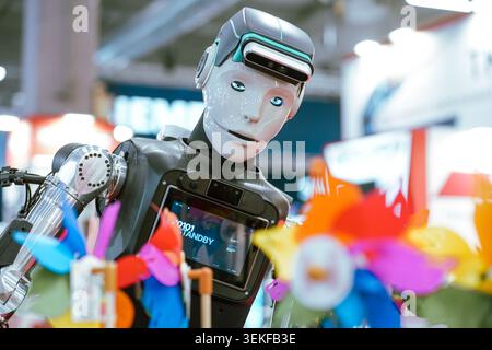 An advanced humanoid robot during a public demonstration at an industrial technology exhibition. Stock Photo