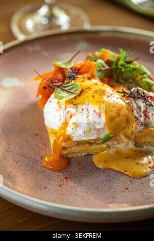 Gourmet eggs benedict with creamy sauce plating Stock Photo