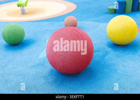 Colorful rubber spheres on modern kids playground with safety surface Stock Photo
