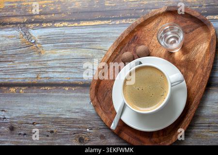 Warm coffee sits in a white cup Stock Photo