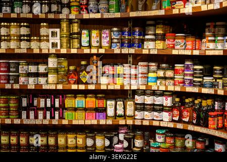 Groceries filling shelves in local market offering a wide range of condiments and jams Stock Photo