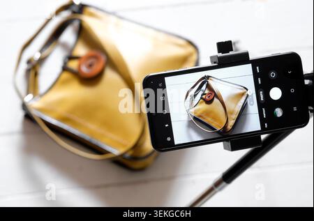 smartphone on tripod taking photo of handbag for online auction site Stock Photo