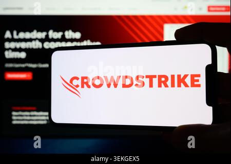 Paris, France - June 2, 2026: Hand holding a smartphone displaying the CrowdStrike logo and website homepage Stock Photo