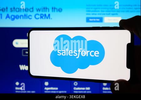 Paris, France - June 2, 2026: Hand holding a smartphone displaying the Salesforce logo and website interface Stock Photo