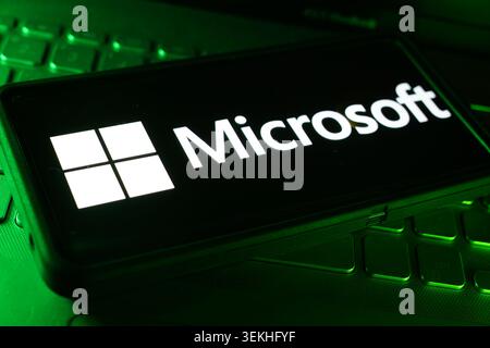 Microsoft Company Logo On Screen Display With Computer Technology Keyboard Background And Digital Business Workspace Setting Stock Photo