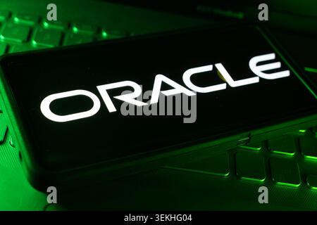 Oracle Company Logo On Screen Display With Computer Technology Keyboard Background And Enterprise Software Business Environment Stock Photo