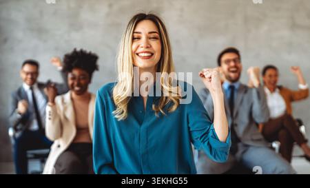 Joyful, excited diverse entrepreneurs are celebrating their success and the great work environment Stock Photo