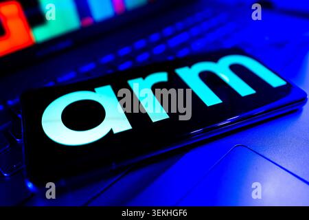 ARM Holdings Corporate Logo Displayed On Mobile Screen With Stock Financial Chart Background Stock Photo