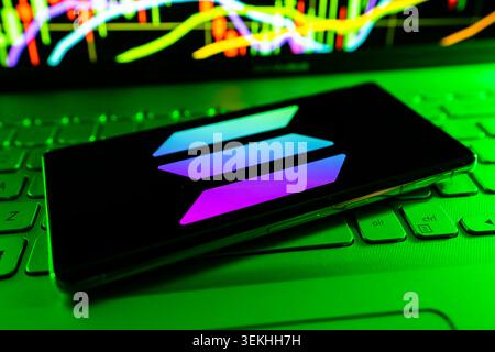 Solana Cryptocurrency Logo Displayed On Mobile Screen With Stock Financial Chart Background Stock Photo
