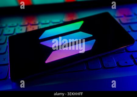 Solana Cryptocurrency Logo Displayed On Mobile Screen With Stock Financial Chart Background Stock Photo