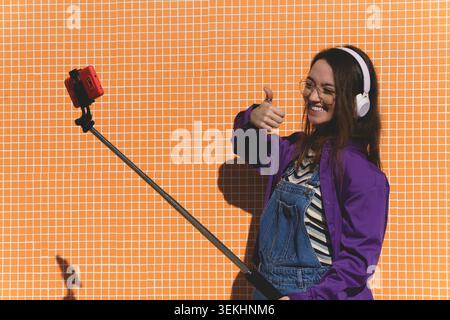 Young social media influencer recording video content outdoors Stock Photo