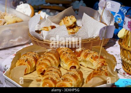 Baked goods sit on display at a local market in the afternoon sun Stock Photo
