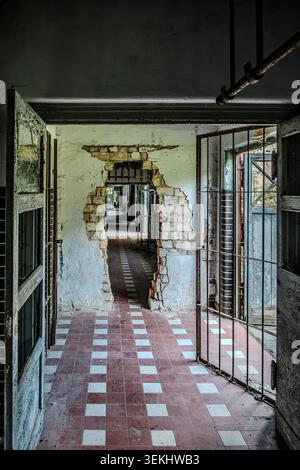 Long and dilapidated corridor in the former pulmonary sanatorium and abandoned site of Grabowsee Sanatorium, Oranienburg, Brandenburg, Germany. Stock Photo