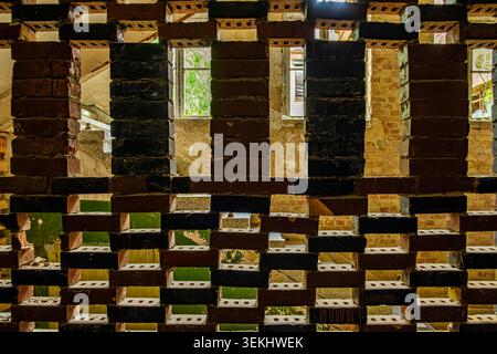 A perforated partition wall in the hallway, former pulmonary sanatorium and abandoned site of Grabowsee Sanatorium, Oranienburg, Brandenburg, Germany. Stock Photo