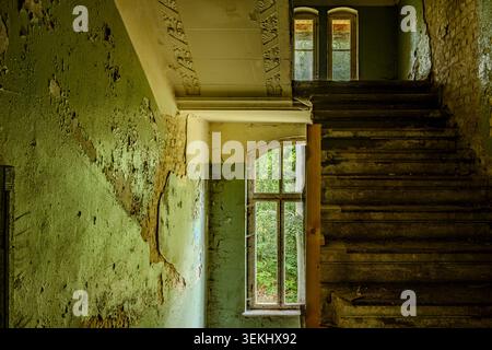 Staircase in a dilapidated building, former pulmonary sanatorium and abandoned site of Grabowsee Sanatorium, Oranienburg, Brandenburg, Germany. Stock Photo