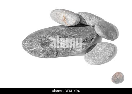 Horizontal wide shot of a cluster of smooth river stones isolated on white or transparent background. Organic mineral shapes with detailed grain Stock Photo