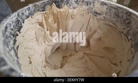Mixed plaster paste in construction bucket closeup Stock Photo
