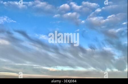 Unique Veil Cloud Formations across a Bright Blue Sky over Switzerland Stock Photo