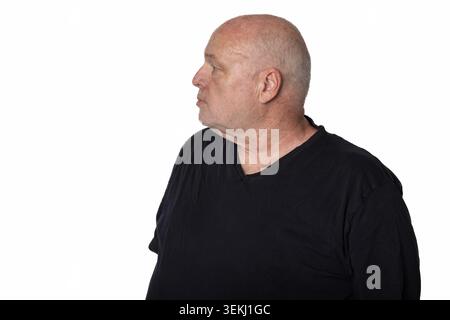 60 Year Old Man in Black T Shirt Looking Left Isolated on White Background Stock Photo