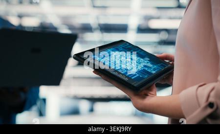 Optimizing AI performance, devices and team of technicians in data center using deep learning. Brainstorming, neural network automation and software developers in data center, camera B Stock Photo