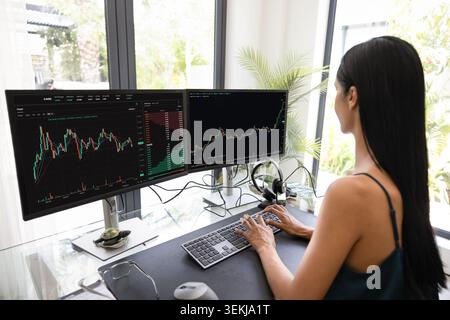 Focused woman analyzing financial charts and project data Stock Photo