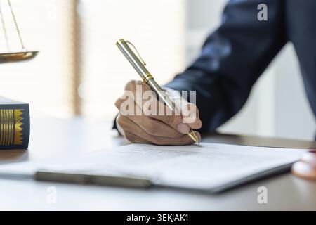 Close up image of businessman hand putting personal signature on contract document Stock Photo