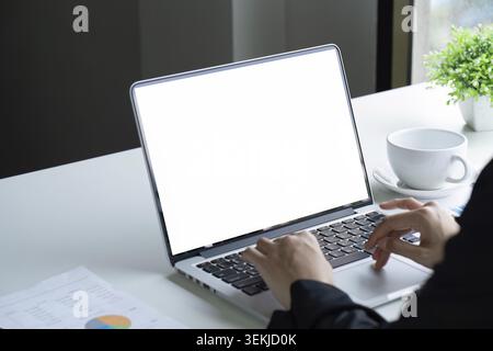 Closeup shot of hands using laptop and typing on keyboard, searching information. blank screen Stock Photo