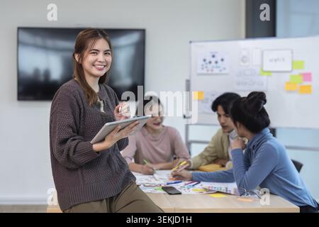 Team of ux developer and ui designer brainstorming interface wireframe design. Creative digital development agency Stock Photo