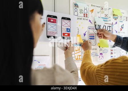 Close up ux developer and ui designer brainstorming interface wireframe design.Creative digital development agency Stock Photo