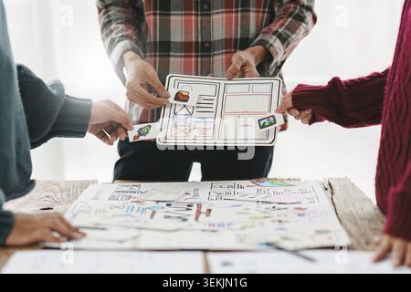 Close up ux developer and ui designer brainstorming interface wireframe design.Creative digital development agency Stock Photo