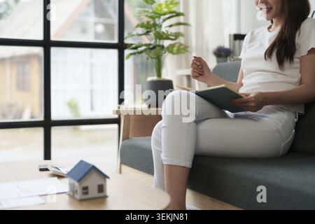 Asian accounting professional calculating household bills, reviewing and analyzing household bills, and filing tax returns Stock Photo