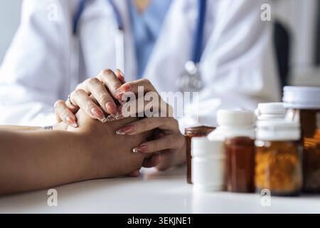 Close up view of doctor touching patient hand, showing empty and kindness Stock Photo