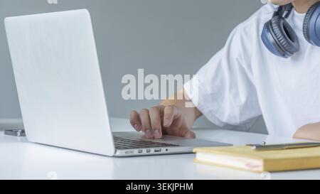Closeup shot of hands using laptop and typing on keyboard, searching information Stock Photo