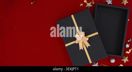 Top view photo of black gift boxes with golden ribbon bow tag and empty open gift box Stock Photo