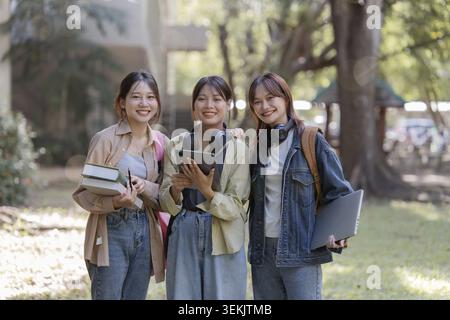 University students using a digital tablet while walking to next class Stock Photo