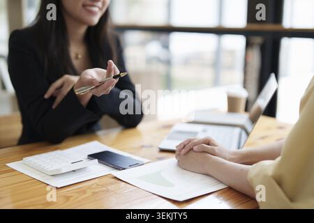 Close up of Diverse colleagues gather brainstorm discuss financial statistics at office meeting. finance, teamwork, Big data Graphs Charts concept Stock Photo