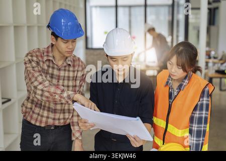 Group of architects and engineers discuss about construction blueprint Stock Photo