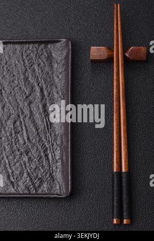 Empty slate board with wooden chopsticks for Asian food. Empty slate board as a food background for your design Stock Photo