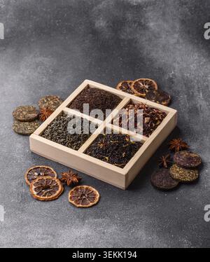 A box of various dry teas, black, green, herbal, and fruit, with flavored additives. A set of different tea varieties as a backdrop for your design Stock Photo