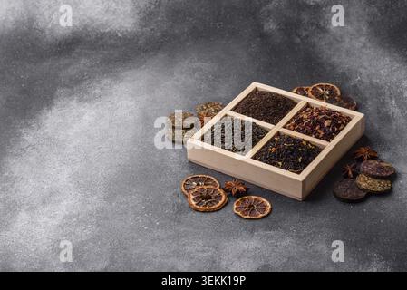 A box of various dry teas, black, green, herbal, and fruit, with flavored additives. A set of different tea varieties as a backdrop for your design Stock Photo