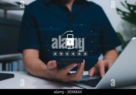 Password Reset Security and Forgotten Password Recovery Concept. User using smartphone and laptop with padlock, hidden passcode, and refresh arrows Stock Photo